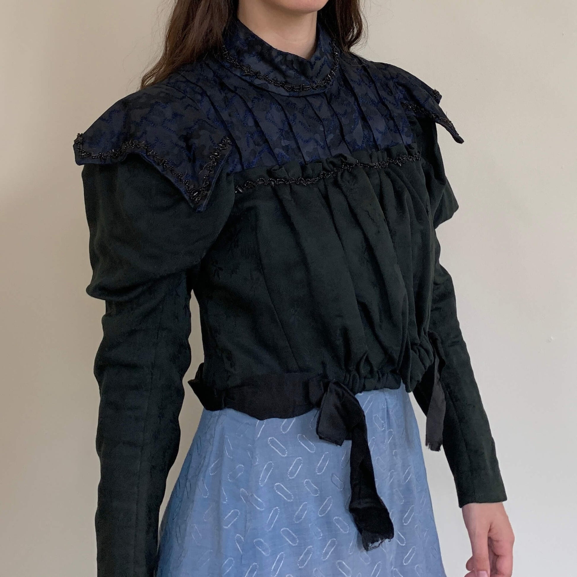 1890s bodice in black wool with navy silk and glass beading paired with a cornflower blue skirt