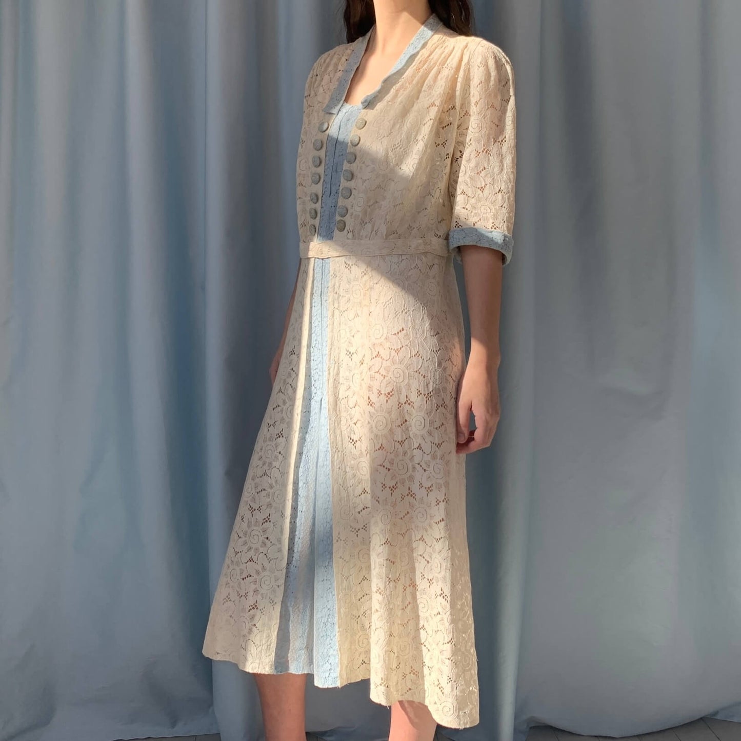 additional view of a model wearing the dress in front of a blue background
