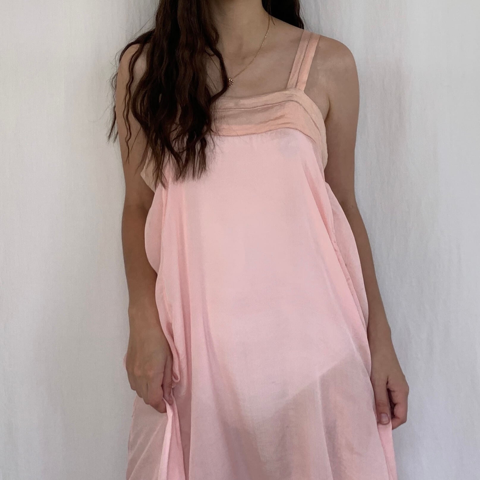 model wearing a vintage 1920s pink silk dress