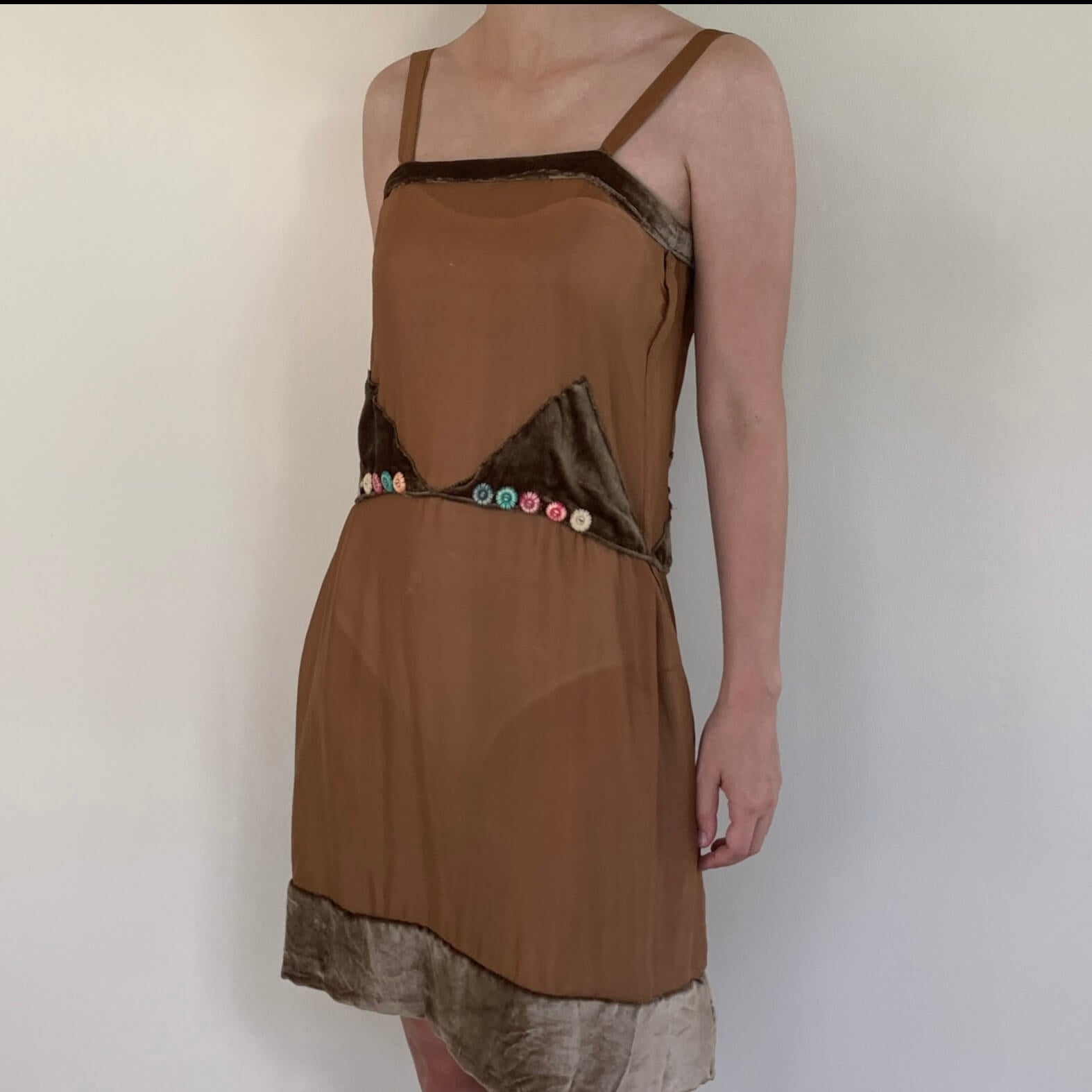 side view of the brown dress on a model