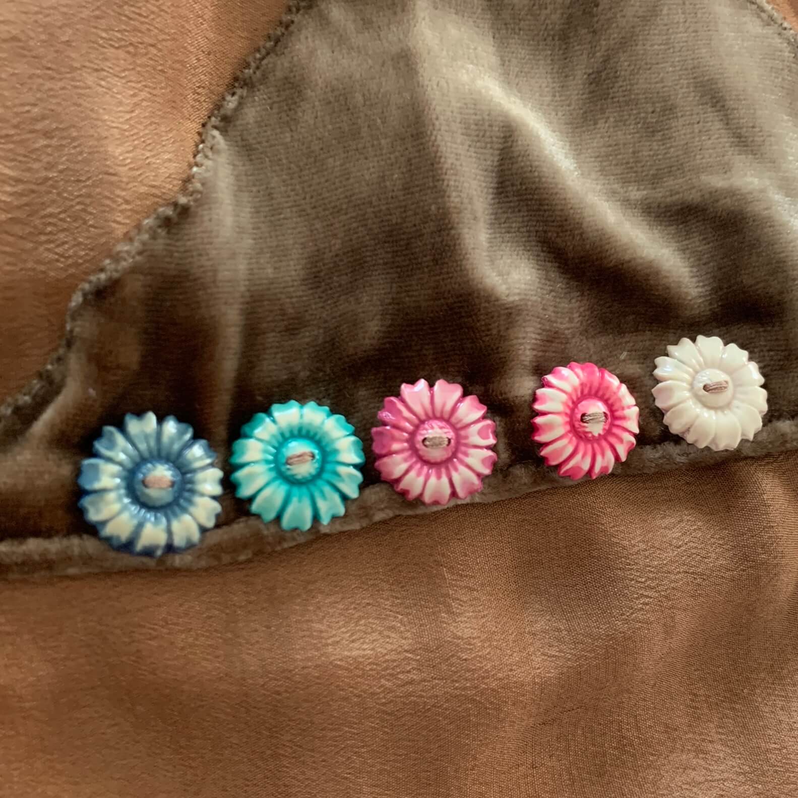 colorful floral buttons on a brown 1920s dress