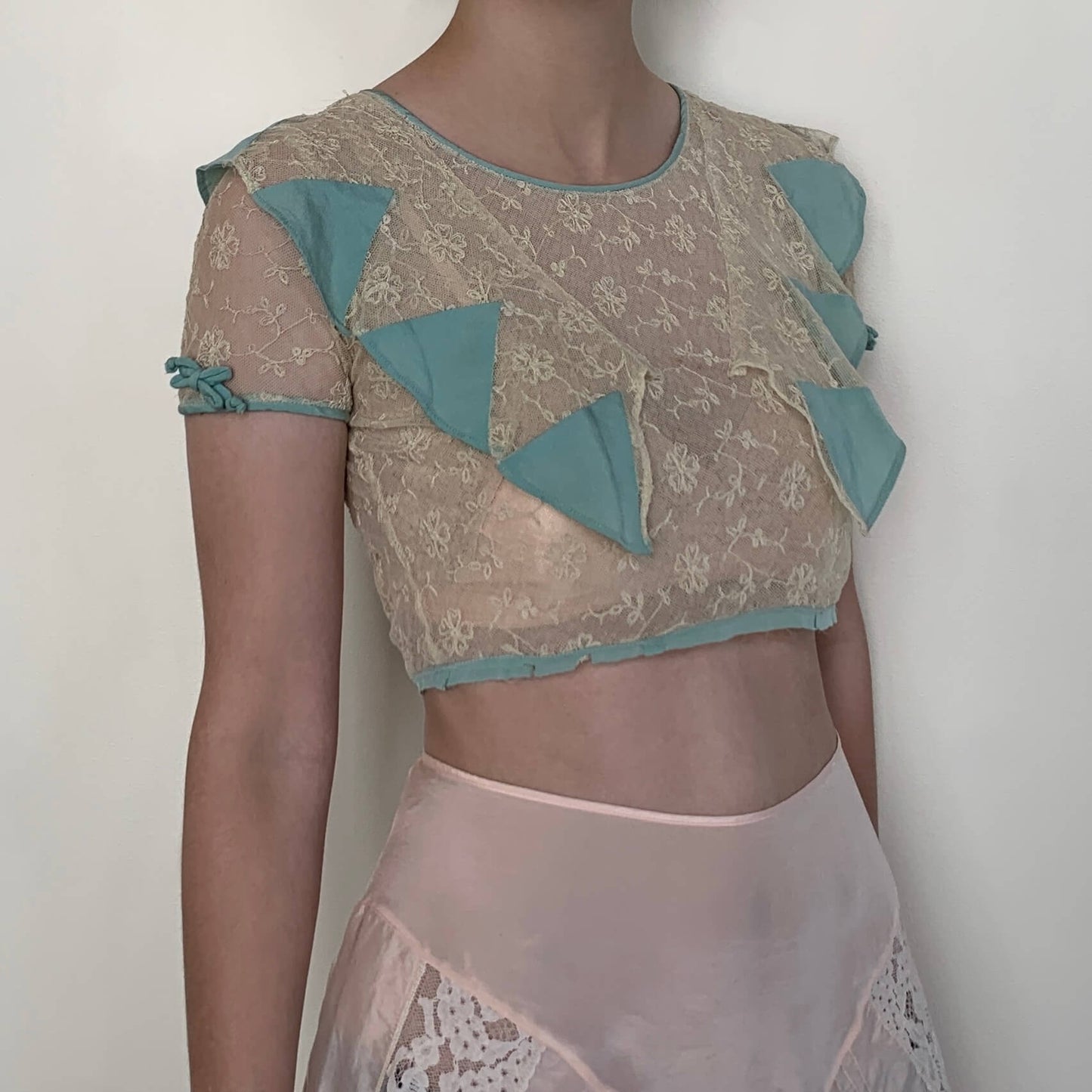 vintage crop top on model in beige lace and teal rayon