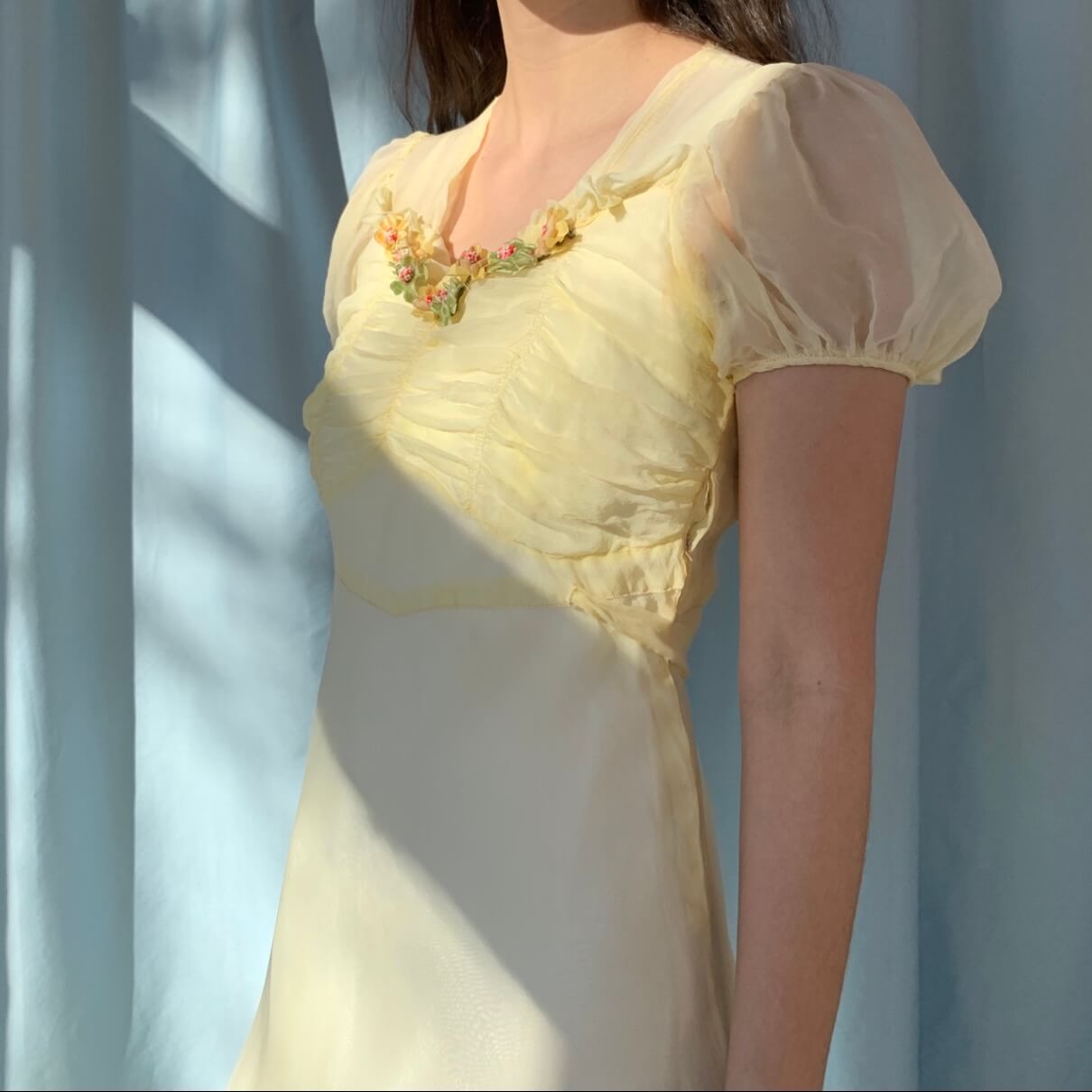 side view of the yellow sheer dress with puff sleeves