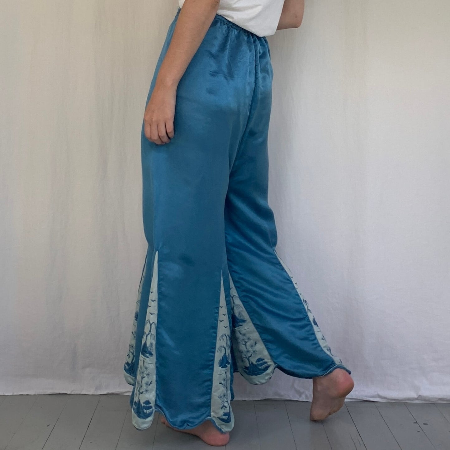 back view on a model of the blue silk beach pants
