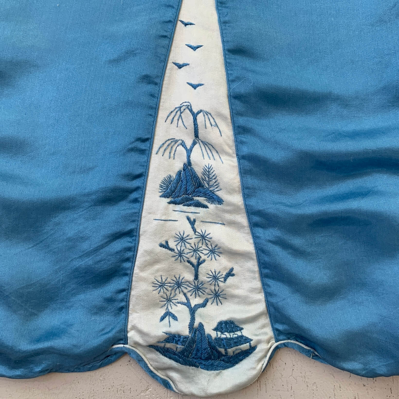 detail of the Chinese embroidery on blue silk