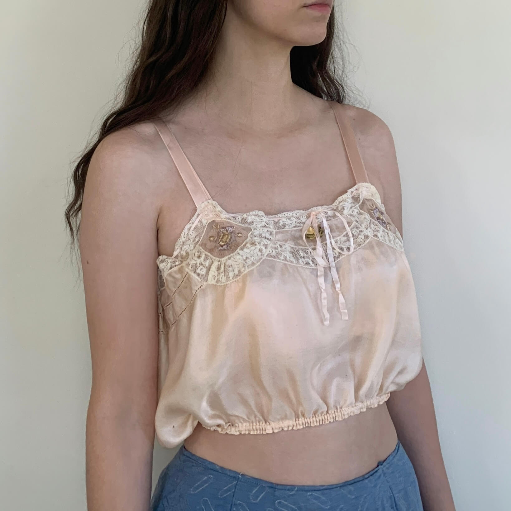 model wearing a pink vintage undergarment
