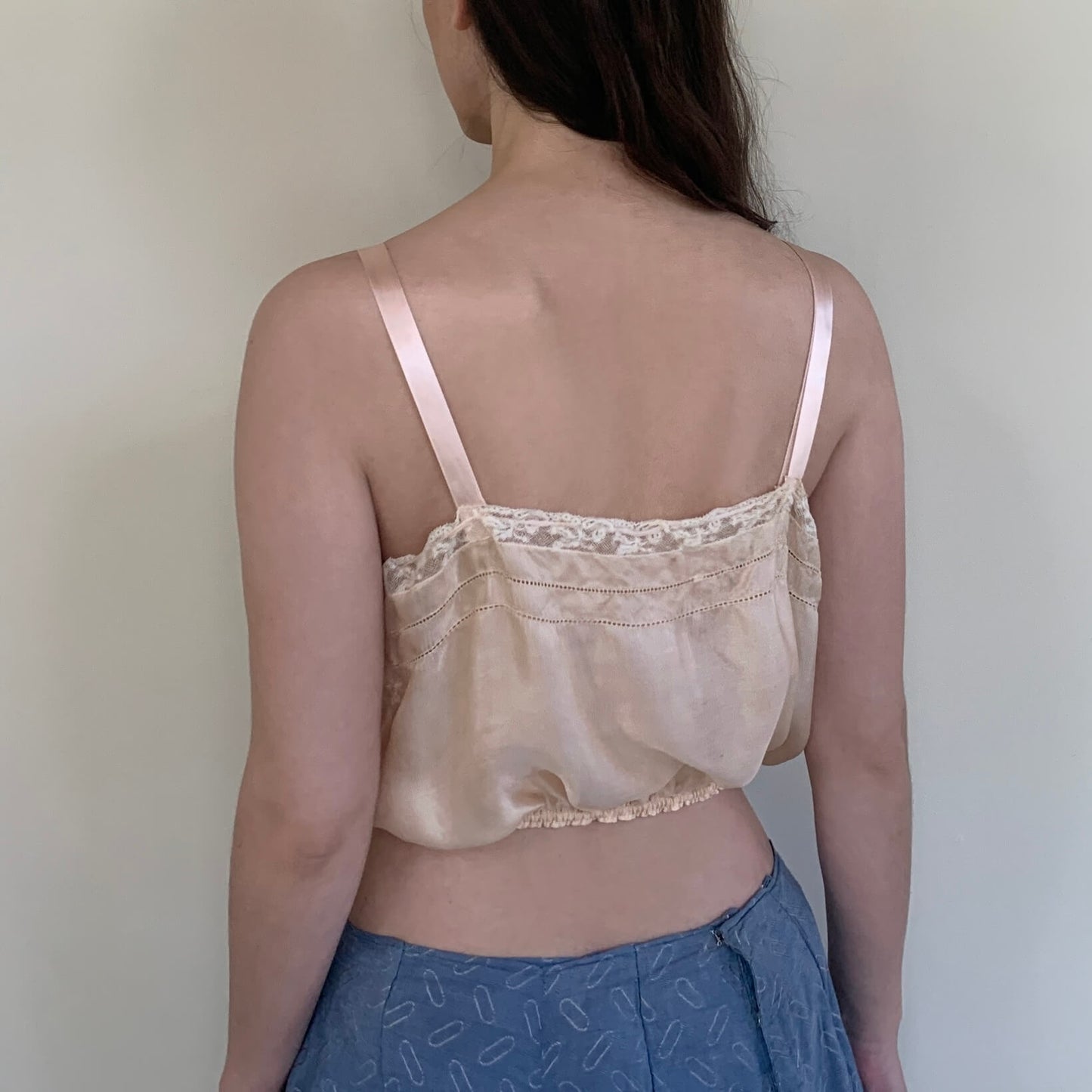 model turned around  in the vintage top