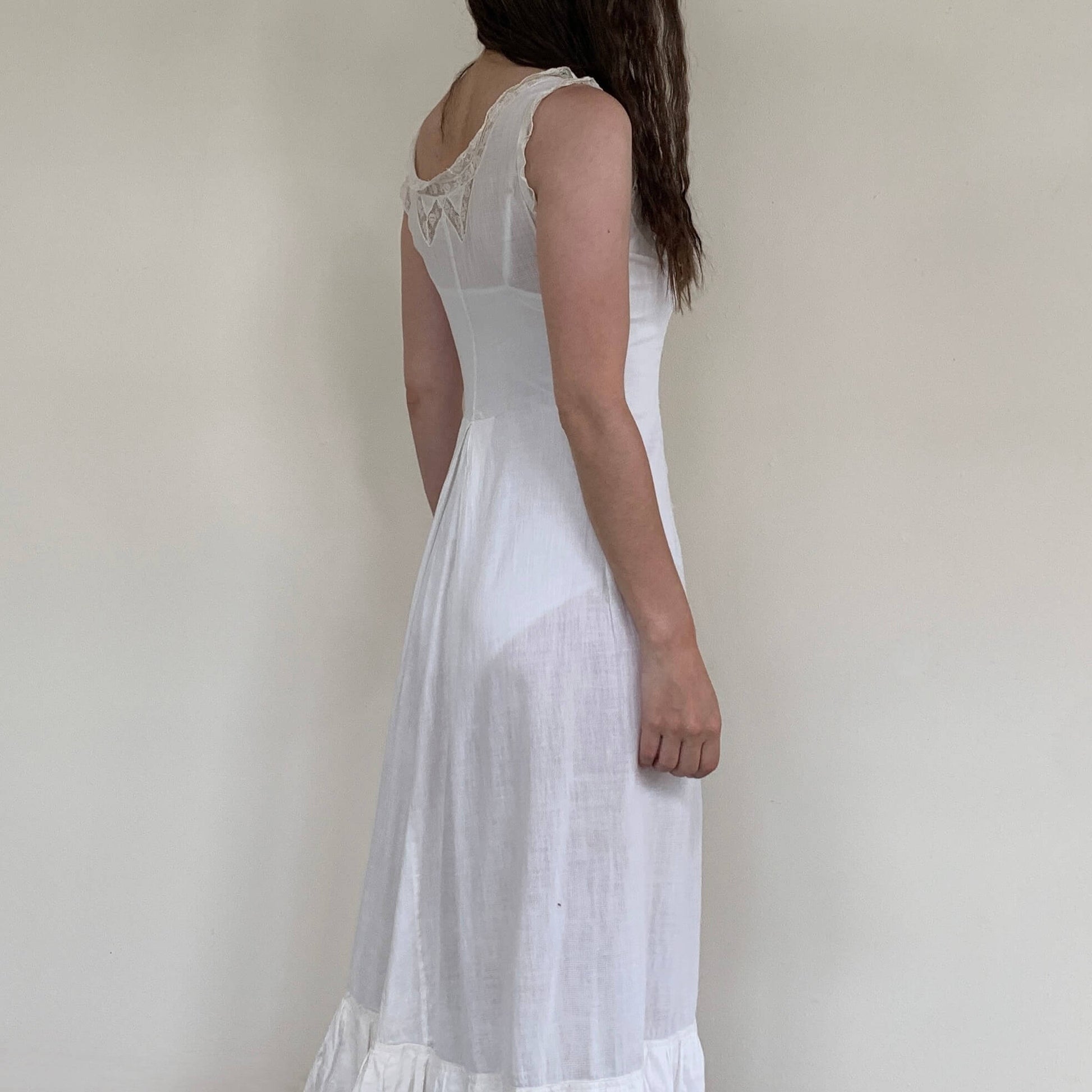 woman wearing a white dress turned to the side