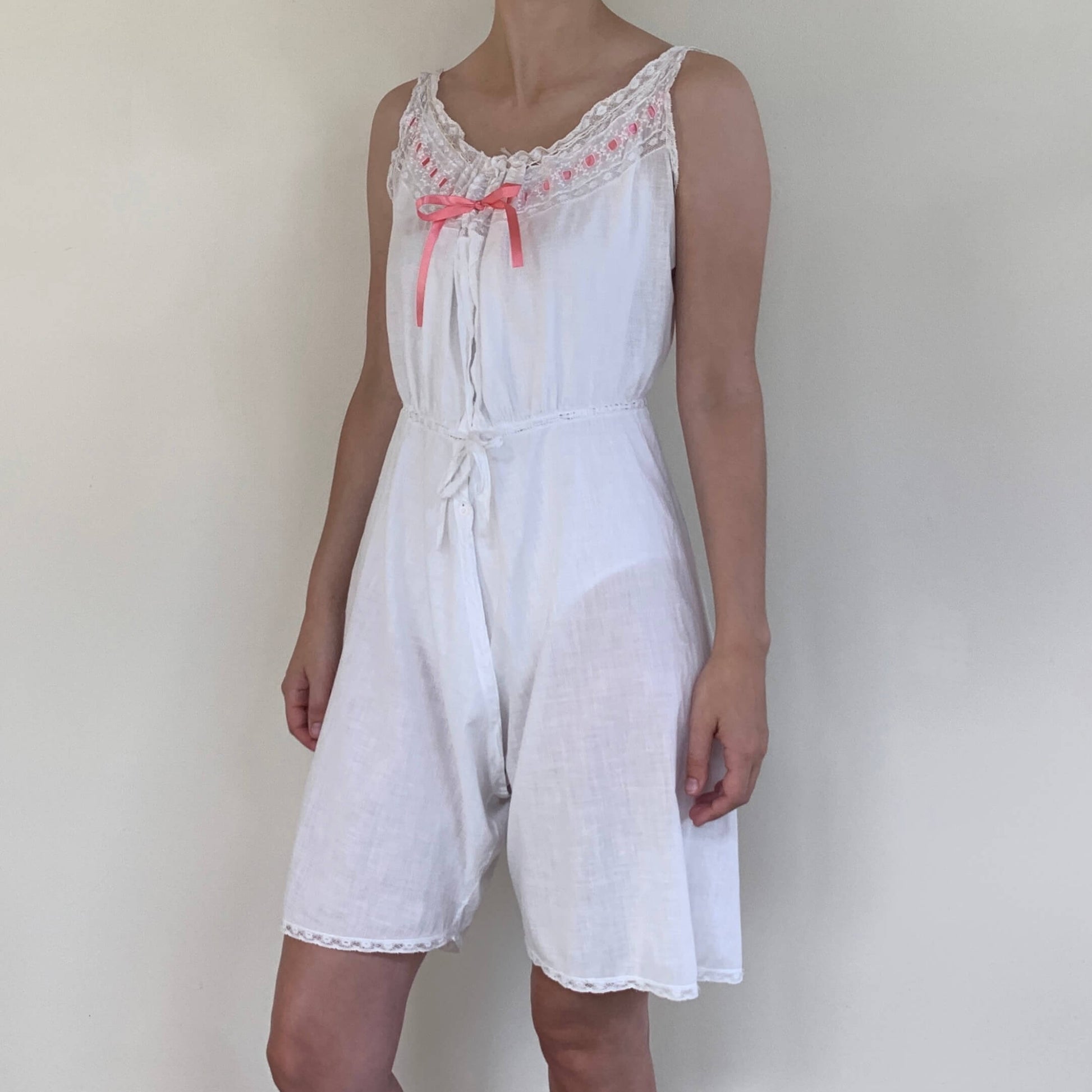 vintage edwardian combinations in white cotton with pink satin bow at the corset cover top