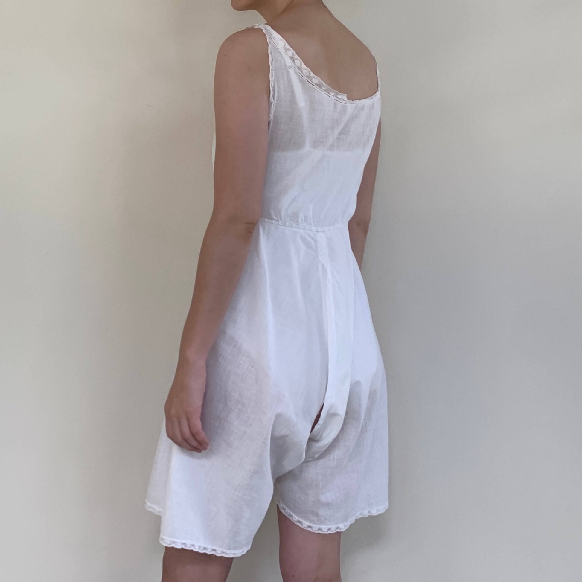 woman wearing a white cotton romper from the 1900s