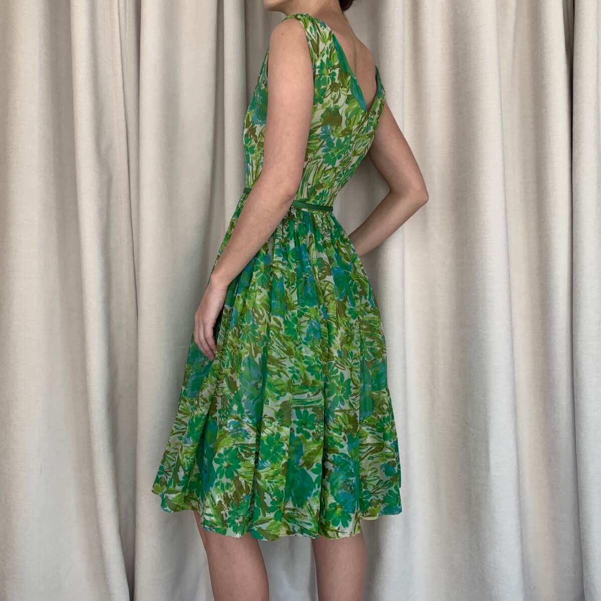 Vintage green 50s dress viewed at an angle