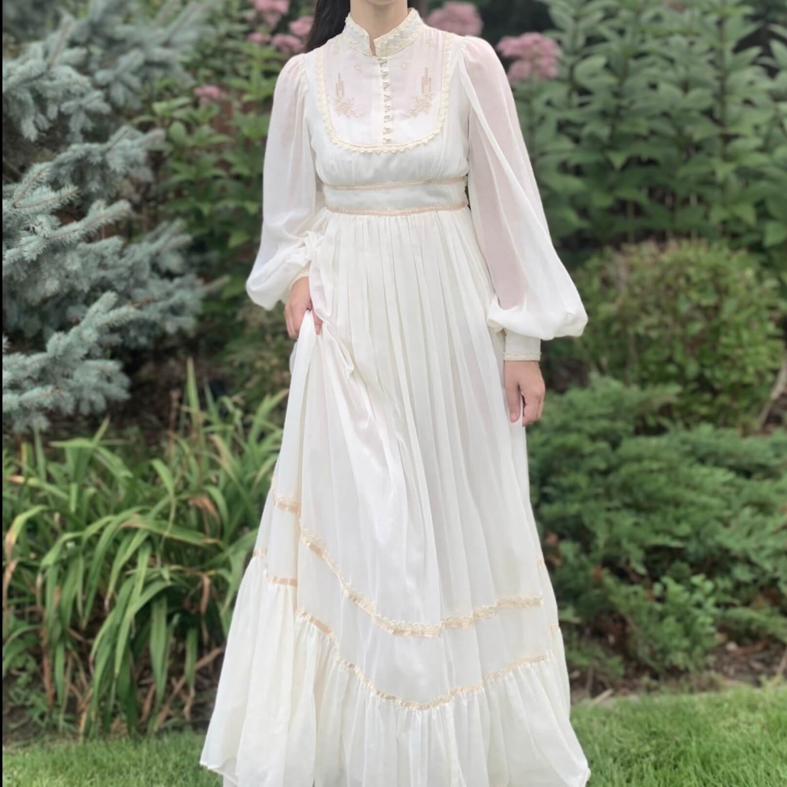 model wearing a Gunne Sax wedding dress in front of trees