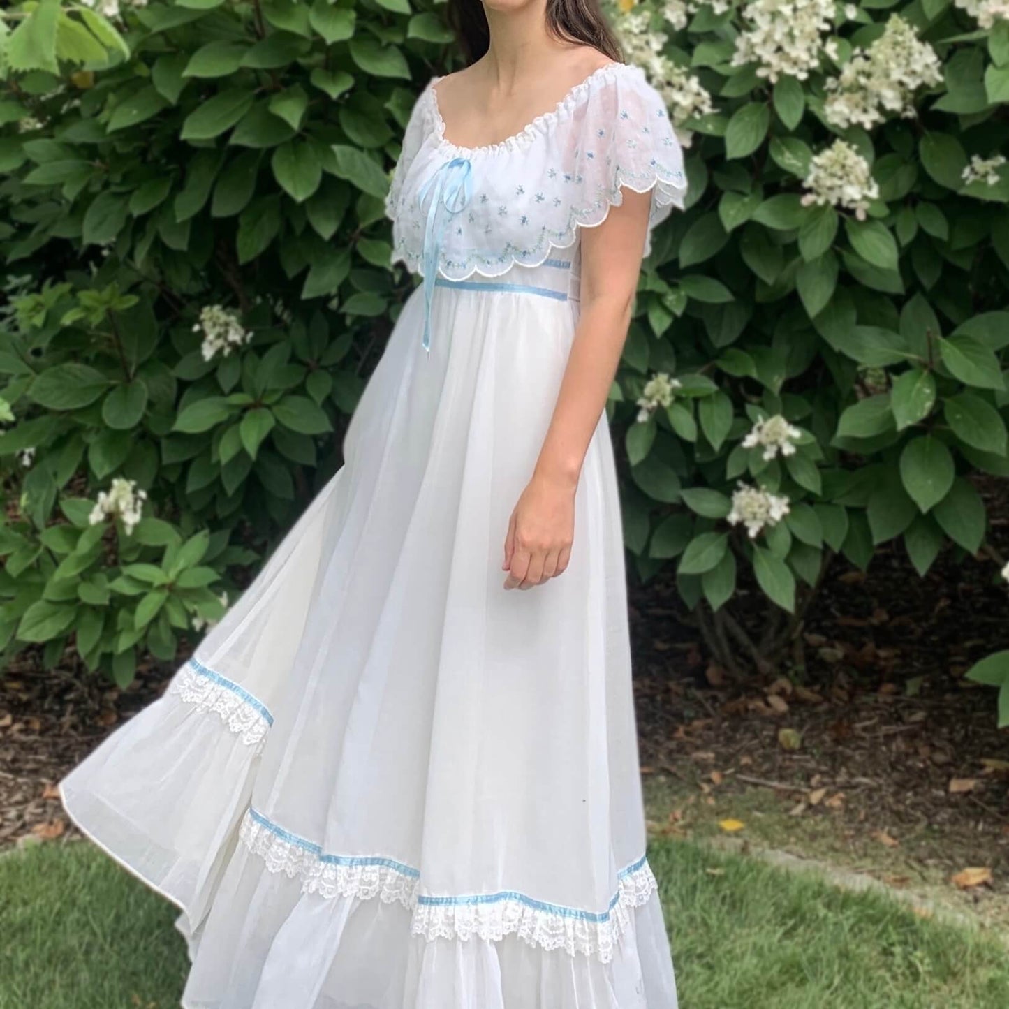 woman wearing a white Gunne Sax prairie dress outside