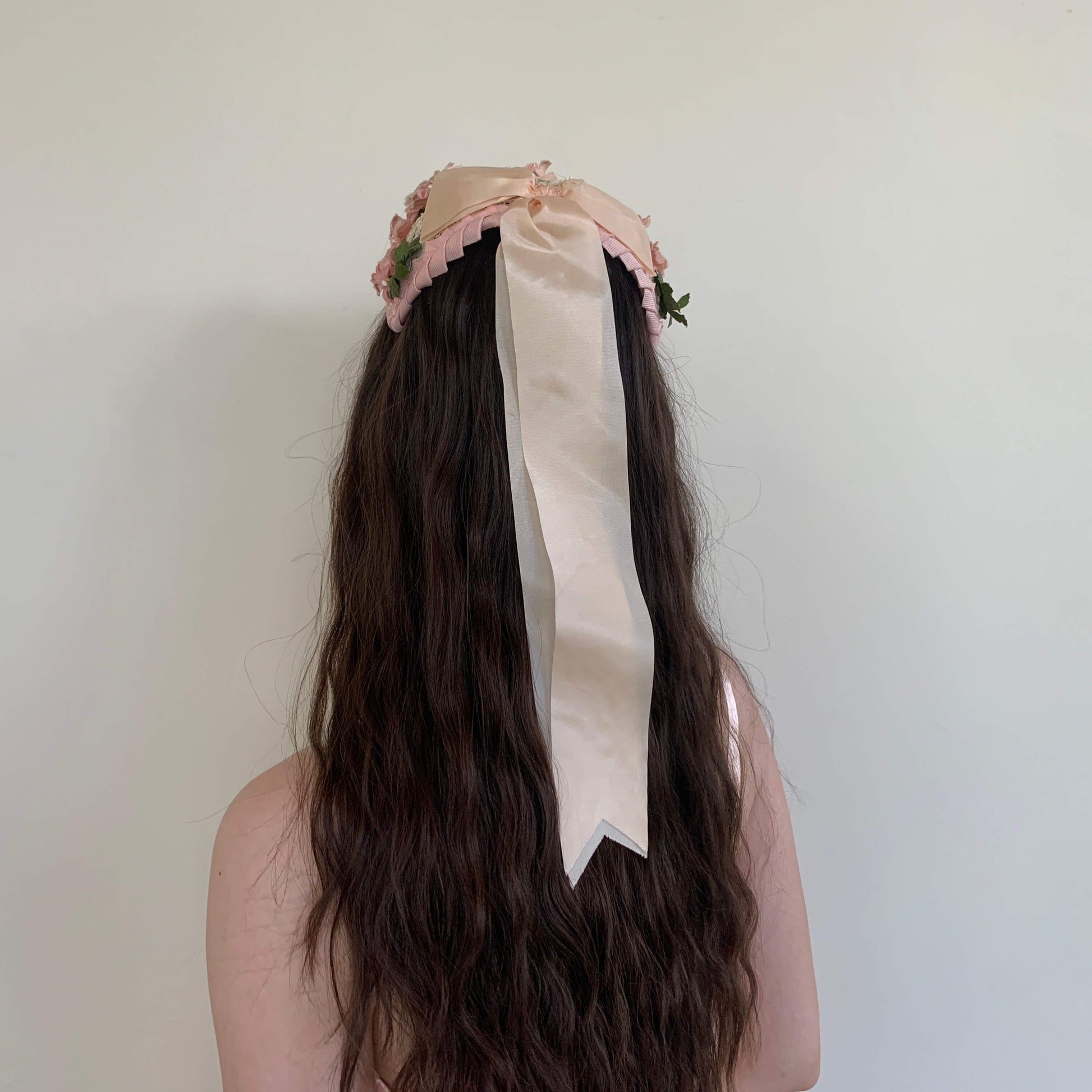 back view of the casque hat showing the long ribbon bow