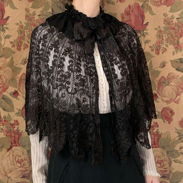 woman wearing an antique outfit with black lace white shirt and black skirt
