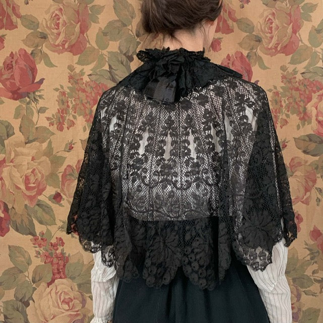 semi sheer antique black lace cape on a model from the back
