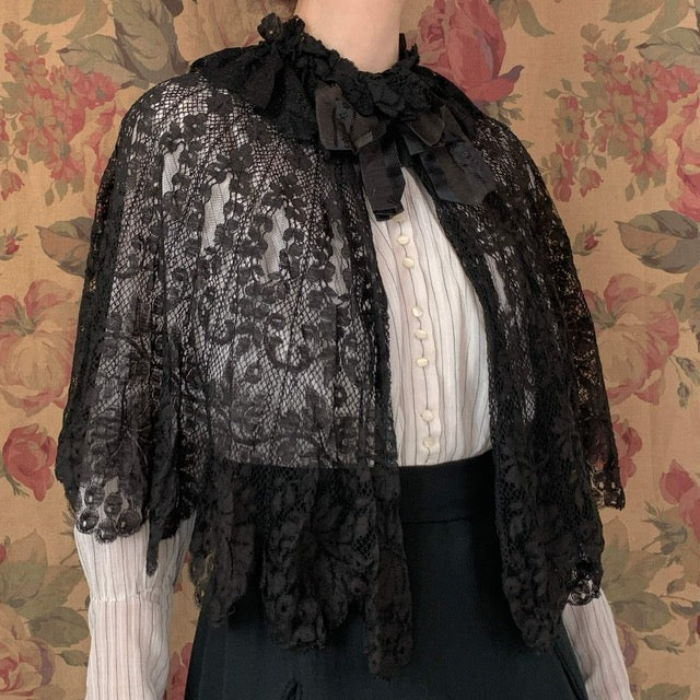 Edwardian Black Lace Cape on model in front of a brown background