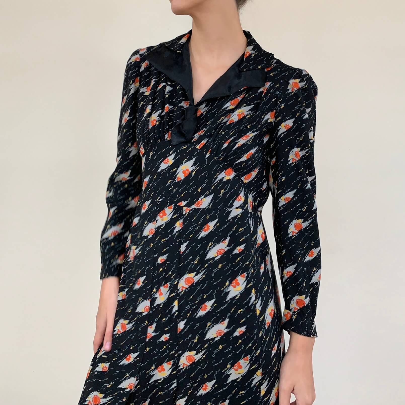 vintage black 1930s dress in a novelty print with a satin collar