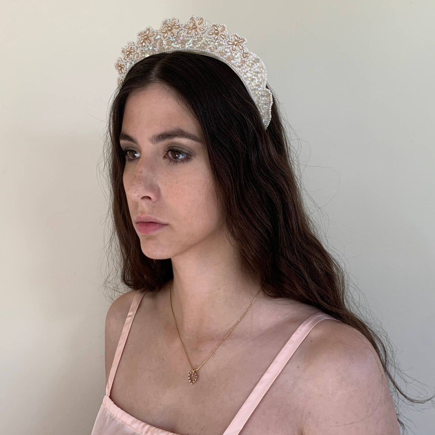 model turned to the side wearing the beaded crown