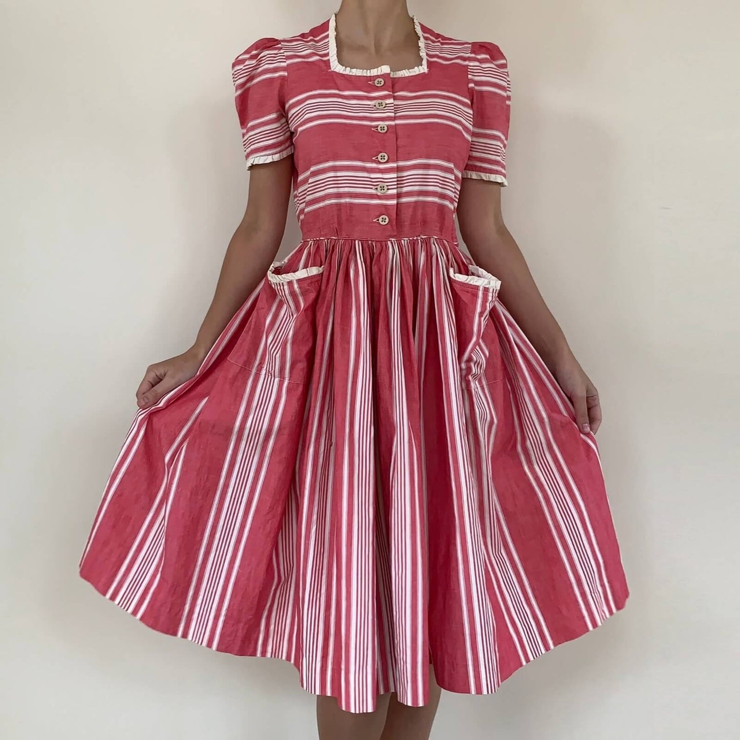 1950s pink and white striped cotton dress on a model