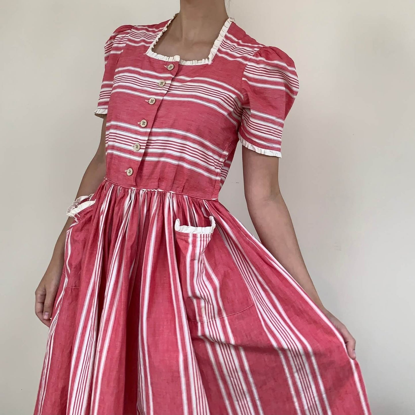 1950s pink vintage dress with patch pockets, puff sleeves, and striped cotton fabric