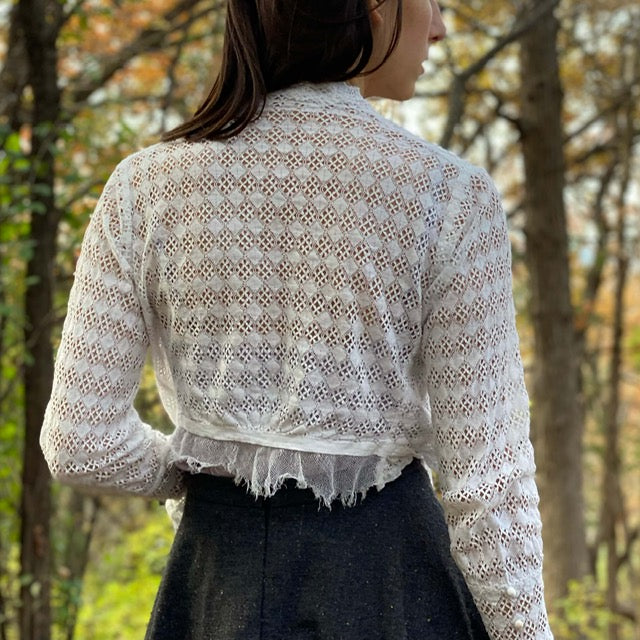 back view showing the lace of a antique white top