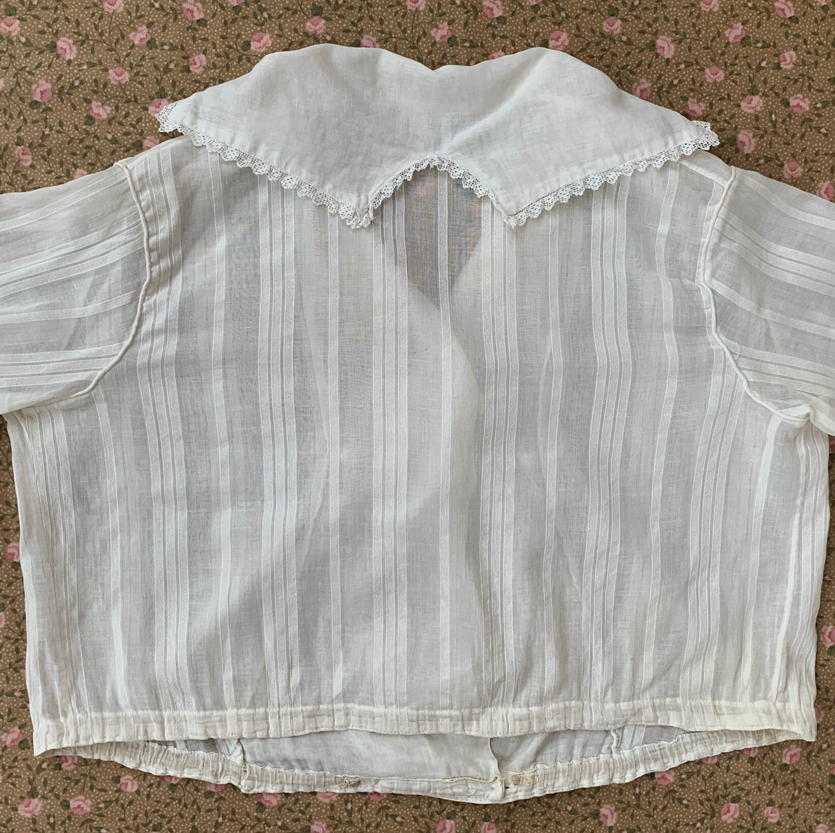 Flat back view of the white blouse